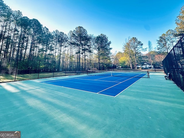 view of tennis court with fence
