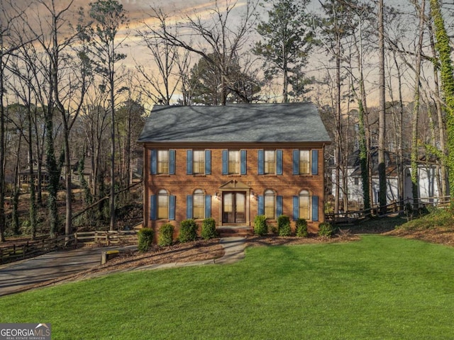 colonial home with a lawn