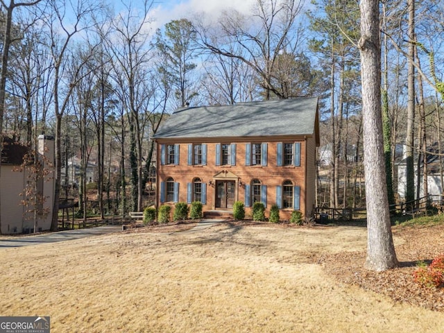 colonial-style house featuring brick siding