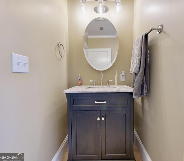 bathroom featuring baseboards and vanity