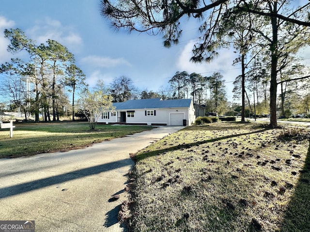 single story home featuring a front yard, a garage, and driveway