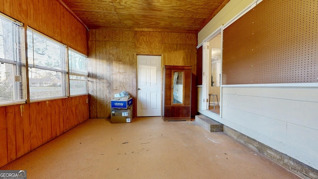 unfurnished sunroom with wooden ceiling