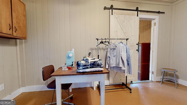 interior space with a barn door and baseboards
