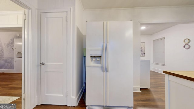 kitchen featuring dark wood finished floors, white cabinets, white refrigerator with ice dispenser, and crown molding