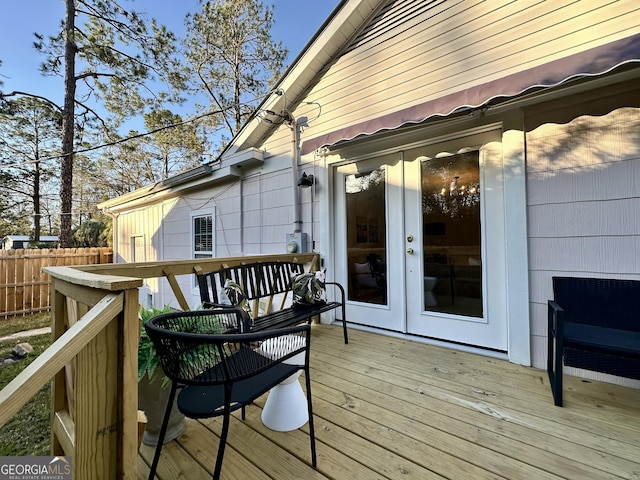 wooden terrace featuring french doors and fence