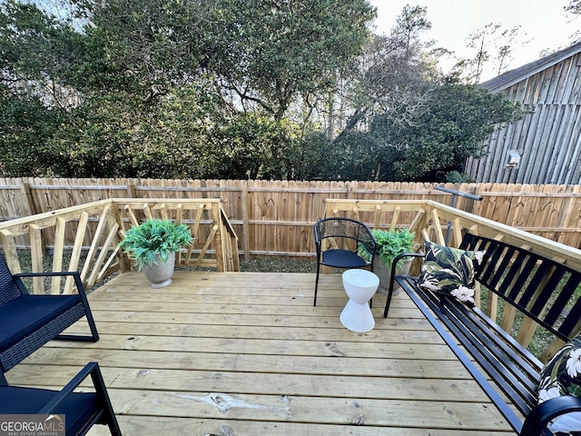 wooden terrace featuring a fenced backyard