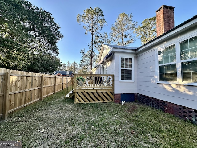 view of yard featuring a deck and fence