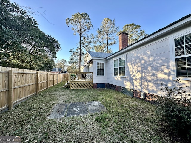 view of yard featuring a wooden deck and a fenced backyard