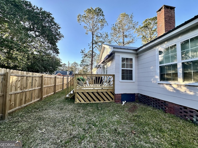 view of yard with fence and a deck