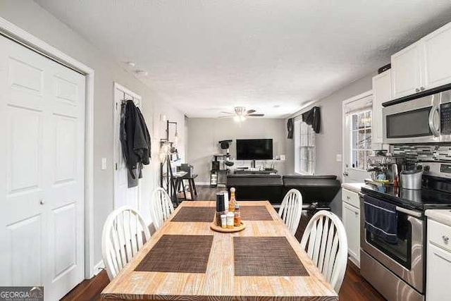 dining room with dark wood finished floors and ceiling fan