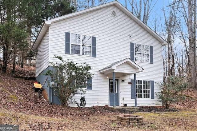 colonial-style house with a fire pit