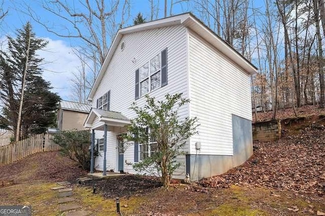 view of side of property featuring fence
