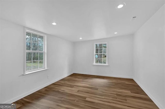 unfurnished room featuring recessed lighting, baseboards, and wood finished floors