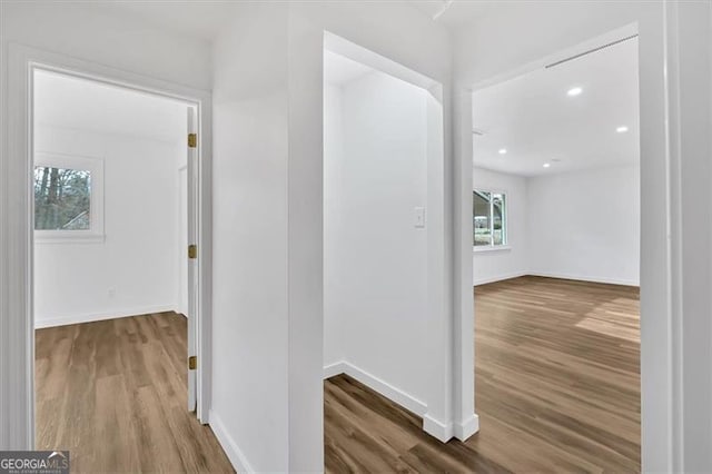 hall with recessed lighting, baseboards, and wood finished floors