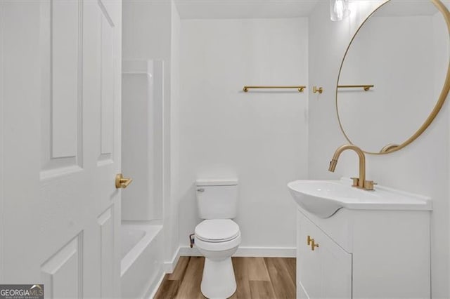 full bath with vanity, toilet, wood finished floors, and baseboards