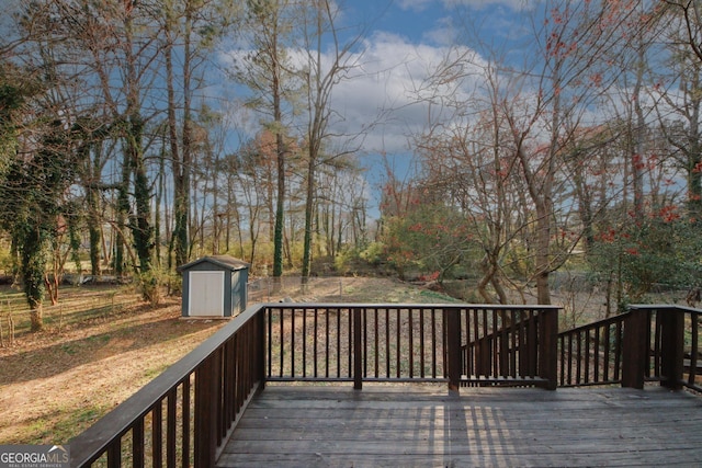 wooden terrace with an outdoor structure and a storage unit