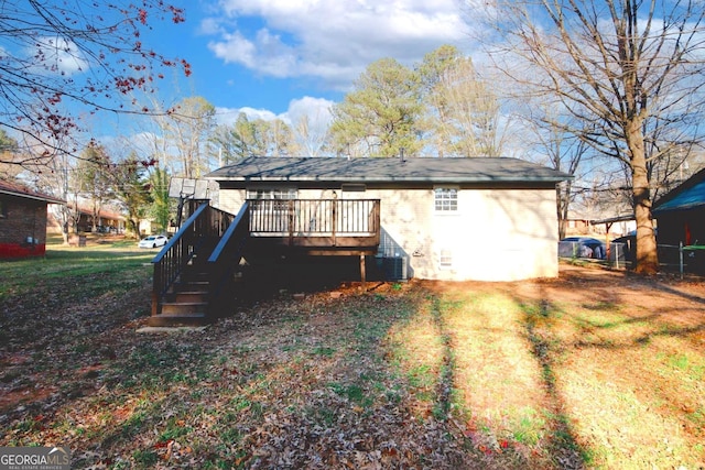 back of house with a deck and stairs