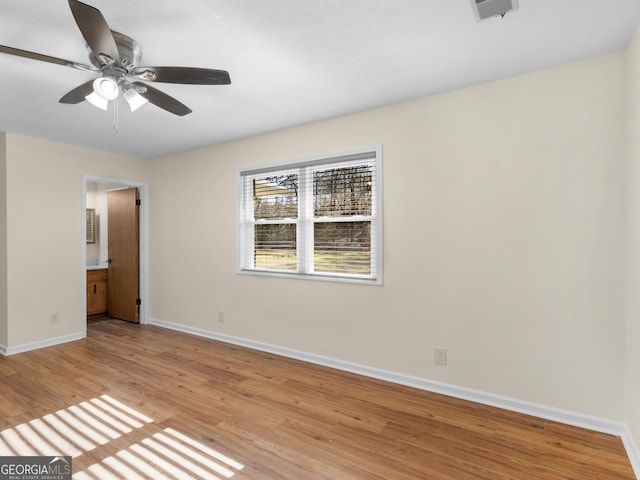 unfurnished bedroom with a ceiling fan, visible vents, baseboards, light wood-style flooring, and ensuite bathroom