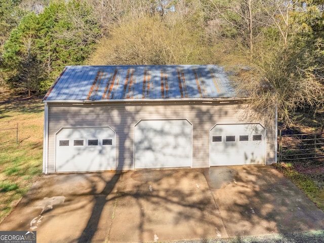 detached garage featuring fence