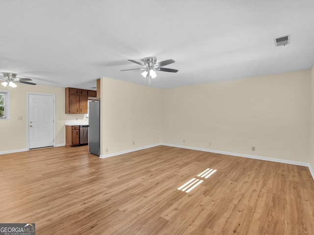 unfurnished living room with visible vents, baseboards, light wood-style floors, and a ceiling fan