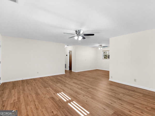 unfurnished living room with light wood-style flooring, baseboards, and ceiling fan