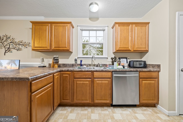 kitchen featuring stainless steel dishwasher, dark countertops, brown cabinetry, and a sink