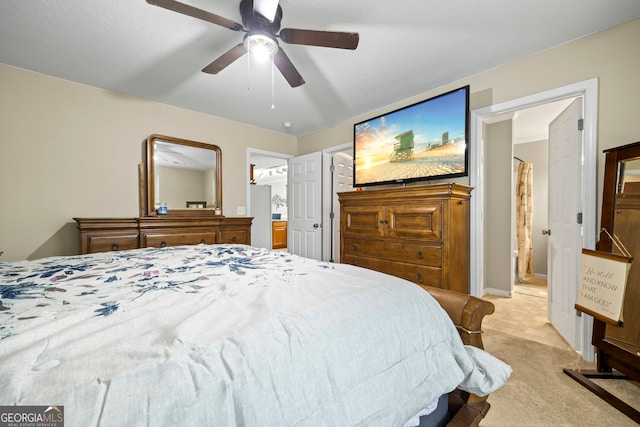 bedroom with light carpet, ceiling fan, and ensuite bathroom