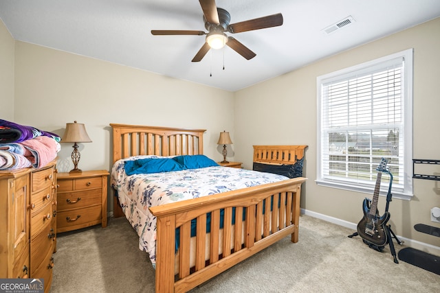 bedroom featuring a ceiling fan, carpet, visible vents, and baseboards