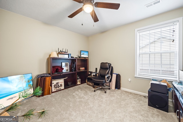 carpeted home office with visible vents, baseboards, and a ceiling fan