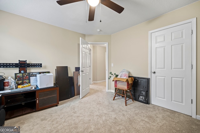 home office with carpet flooring, a ceiling fan, and baseboards