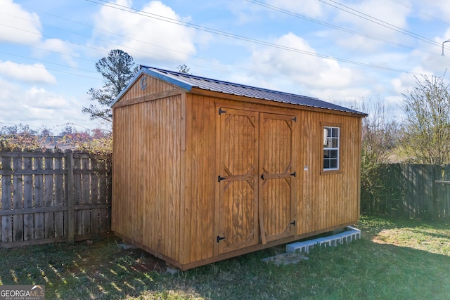 view of shed with a fenced backyard