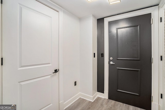 interior space with baseboards and wood finished floors