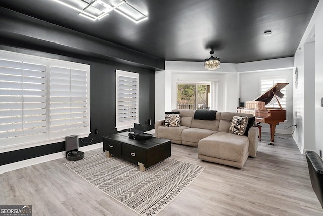 living room featuring baseboards and light wood-style flooring