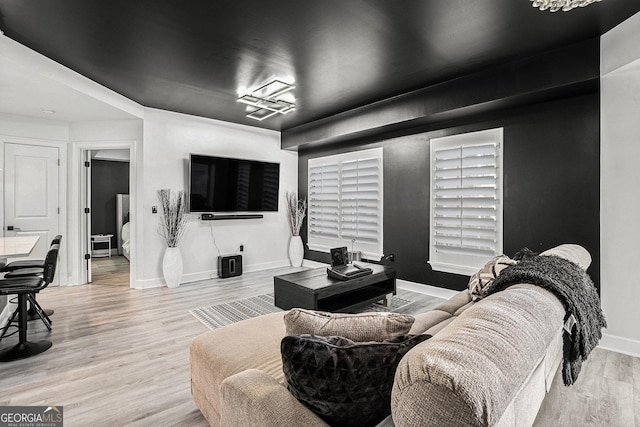 living room with baseboards and wood finished floors