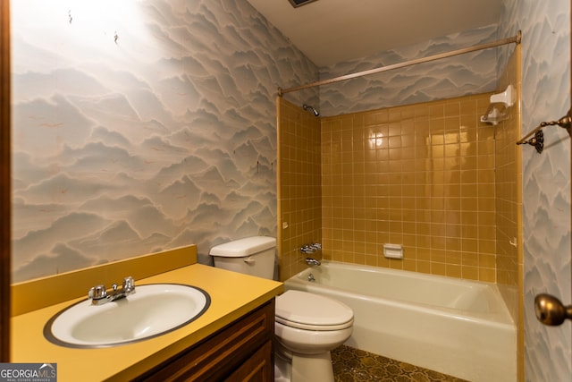 bathroom featuring wallpapered walls, toilet, vanity, and washtub / shower combination