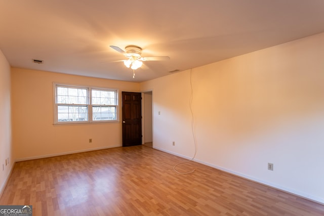 empty room featuring ceiling fan, visible vents, baseboards, and light wood-style flooring