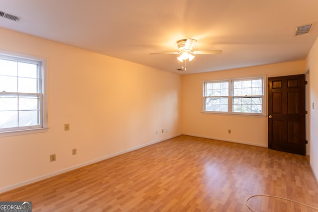 interior space featuring visible vents, baseboards, light wood-style floors, and ceiling fan