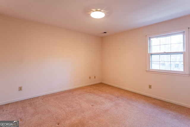 carpeted empty room with visible vents and baseboards