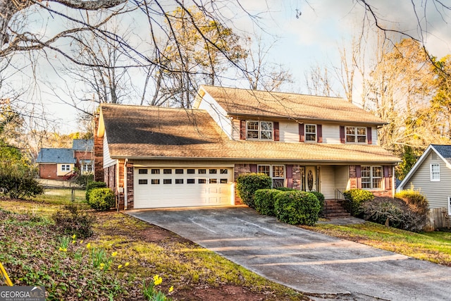 traditional home featuring brick siding, a chimney, concrete driveway, and an attached garage