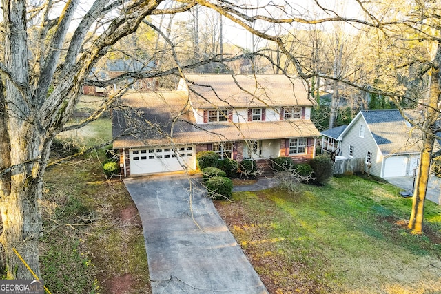 traditional home featuring a front lawn, an attached garage, brick siding, and driveway