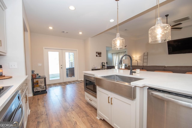 296 Beavers Rd, Grantville, GA 30220 - kitchen with appliances with stainless steel finishes, a sink, light wood-type flooring, white cabinets, and recessed lighting