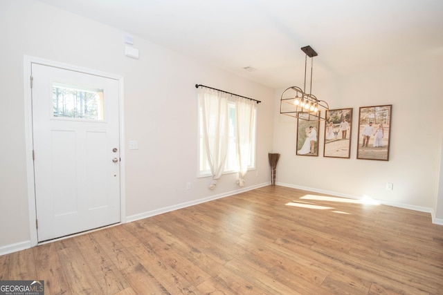 296 Beavers Rd, Grantville, GA 30220 - entrance foyer with light wood finished floors, a chandelier, and baseboards