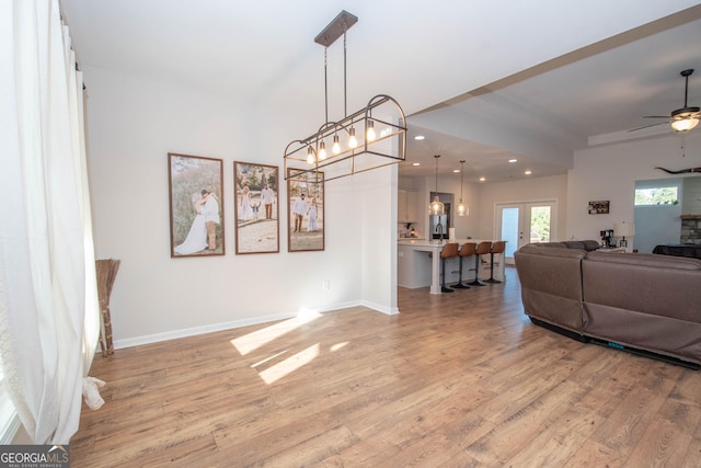 living area featuring recessed lighting, light wood-type flooring, and baseboards