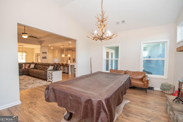 game room with visible vents, baseboards, an inviting chandelier, and wood finished floors