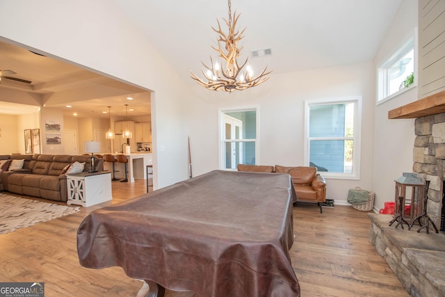 296 Beavers Rd, Grantville, GA 30220 - recreation room with a chandelier, wood finished floors, billiards, lofted ceiling, and a stone fireplace