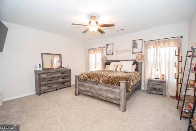 carpeted bedroom featuring visible vents, a ceiling fan, and baseboards