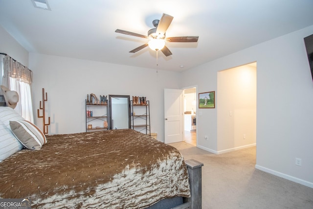 bedroom featuring a ceiling fan, light colored carpet, visible vents, and baseboards