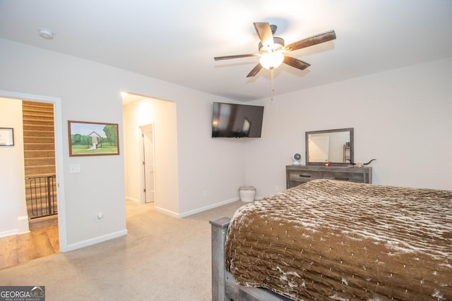 bedroom with light colored carpet and baseboards