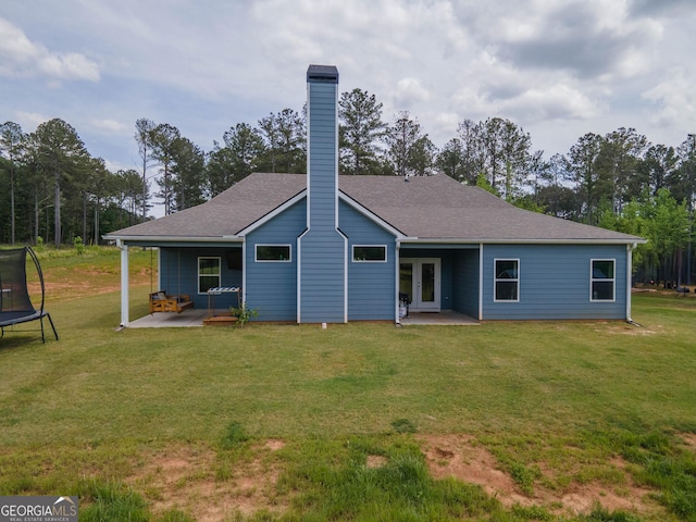 296 Beavers Rd, Grantville, GA 30220 - back of property with a trampoline, a patio area, french doors, and a chimney