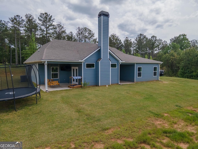 296 Beavers Rd, Grantville, GA 30220 - rear view of property with a trampoline, a chimney, a patio area, and a lawn